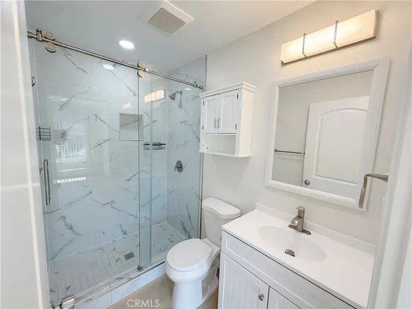 a bathroom with a sink toilet and shower