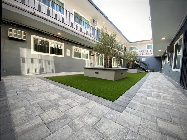 a view of a house with a yard and sitting area