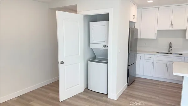 a kitchen with a refrigerator sink and cabinets