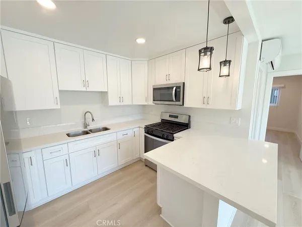 a kitchen with a sink a stove and cabinets