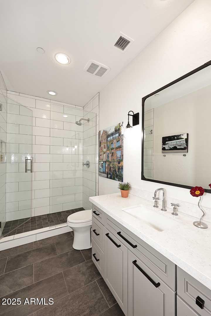 2979 South Lookout Ridge Gold Canyon, AZ 85118 - Photo 20 of 51 a bathroom with a double vanity sink toilet mirror and shower