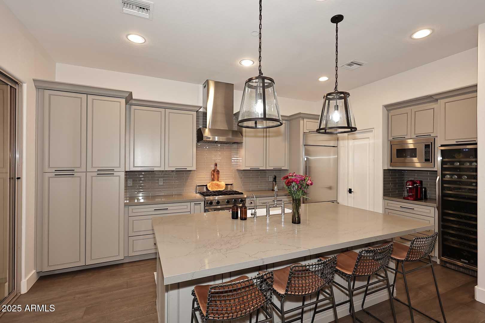 2979 South Lookout Ridge Gold Canyon, AZ 85118 - Photo 10 of 51 a kitchen with stainless steel appliances a dining table chairs and white cabinets