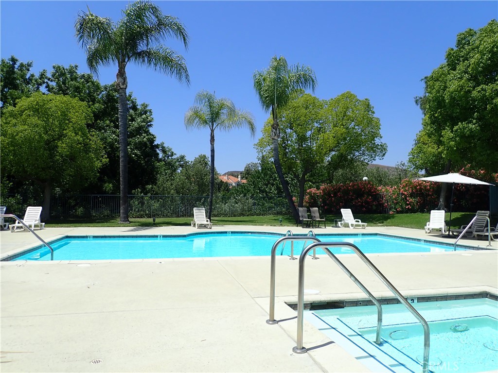 4201 Las Virgenes Road, Unit 108 Calabasas, CA 91302 - Photo 12 of 15 a view of a swimming pool with a yard and palm trees