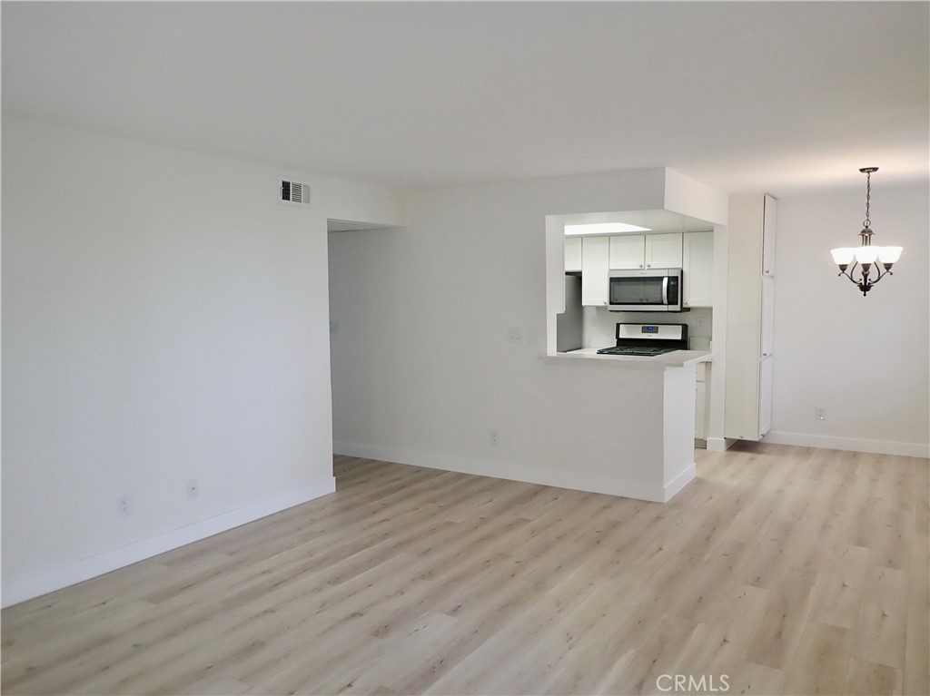 4201 Las Virgenes Road, Unit 108 Calabasas, CA 91302 - Photo 2 of 15 a view of a kitchen with wooden floor electronic appliances and window