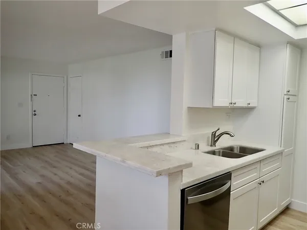 a kitchen with a sink cabinets and stainless steel appliances