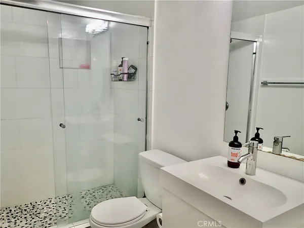 a bathroom with a sink toilet and shower