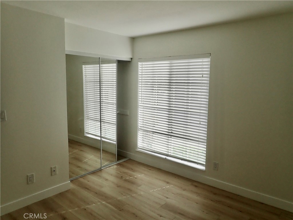 4201 Las Virgenes Road, Unit 108 Calabasas, CA 91302 - Photo 7 of 15 an empty room with wooden floor and windows