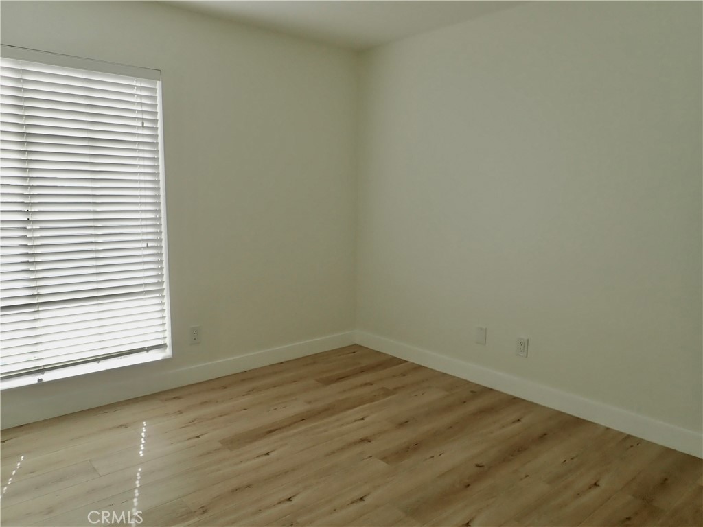 4201 Las Virgenes Road, Unit 108 Calabasas, CA 91302 - Photo 10 of 15 an empty room with wooden floor and windows