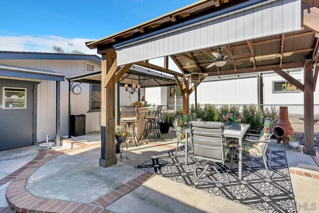 18218 Paradise Mountain Road, Unit 203 Valley Center, CA 92082 - Photo 11 of 68 a view of a chairs and table in patio