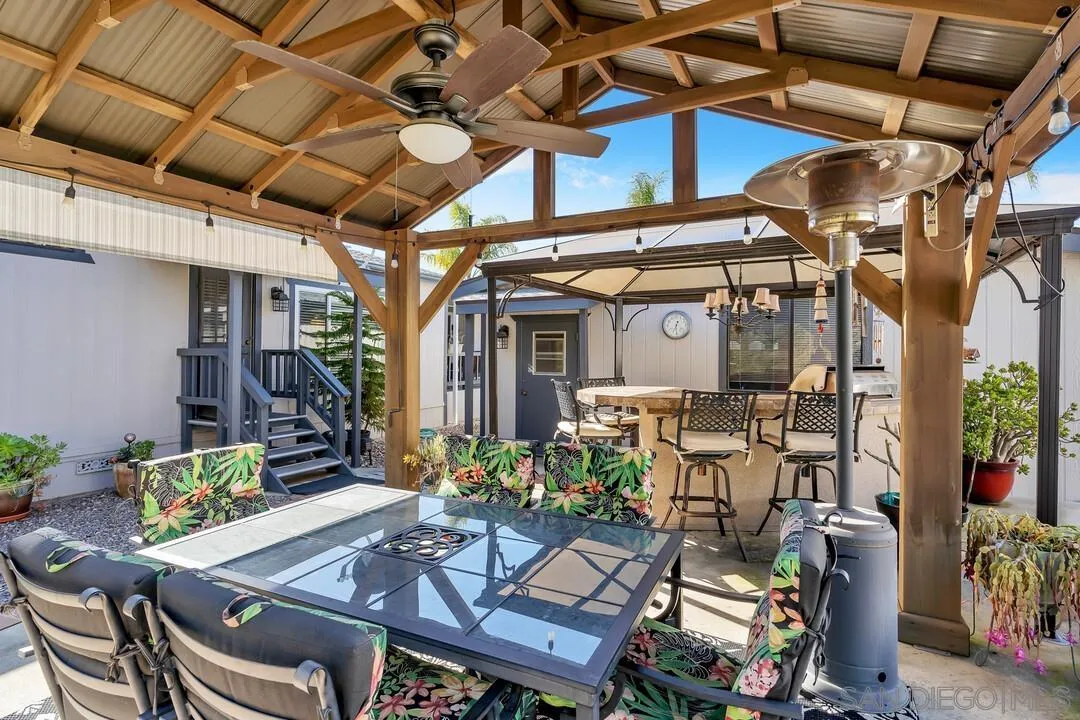 18218 Paradise Mountain Road, Unit 203 Valley Center, CA 92082 - Photo 12 of 68 a view of a patio with table and chairs and potted plants