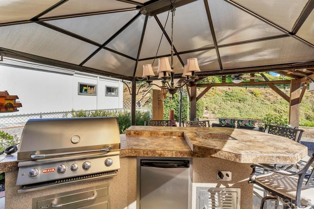 18218 Paradise Mountain Road, Unit 203 Valley Center, CA 92082 - Photo 13 of 68 a kitchen with a stove a sink and a table