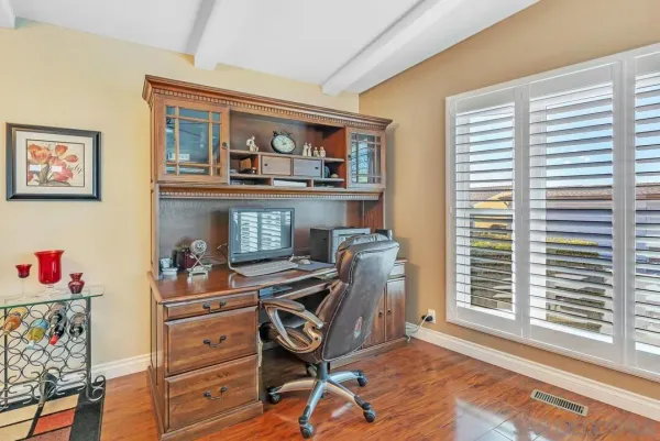 a view of a dining room with furniture wooden floor and chandelier