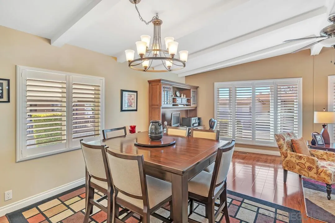 18218 Paradise Mountain Road, Unit 203 Valley Center, CA 92082 - Photo 20 of 68 a dining room with furniture a chandelier and wooden floor