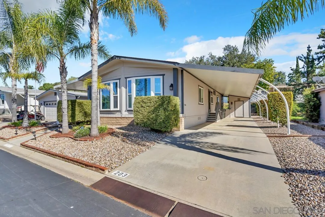 18218 Paradise Mountain Road, Unit 203 Valley Center, CA 92082 - Photo 2 of 68 a front view of a house with garden