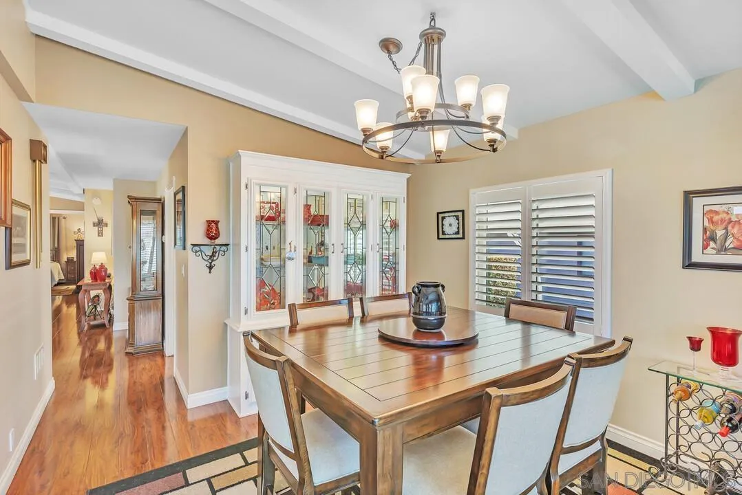 18218 Paradise Mountain Road, Unit 203 Valley Center, CA 92082 - Photo 21 of 68 a view of a dining room with furniture wooden floor and chandelier