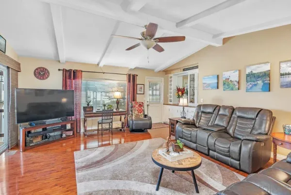 a living room with furniture and wooden floor