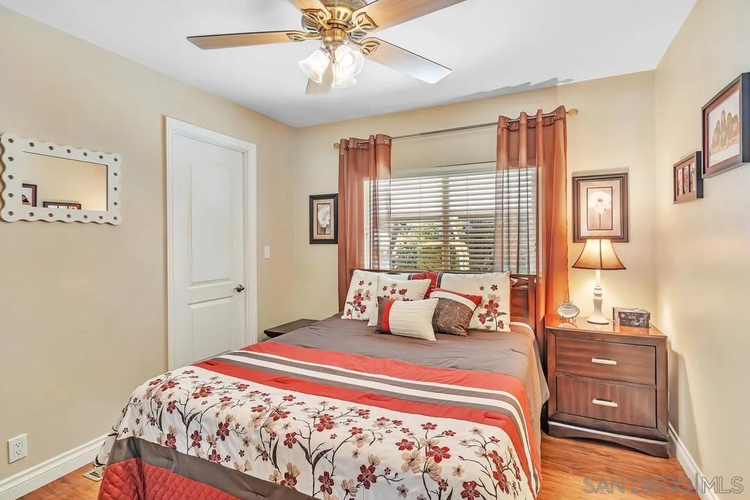 18218 Paradise Mountain Road, Unit 203 Valley Center, CA 92082 - Photo 32 of 68 a bedroom with a large bed and a chandelier