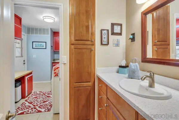 a bathroom with a double vanity sink mirror and shower