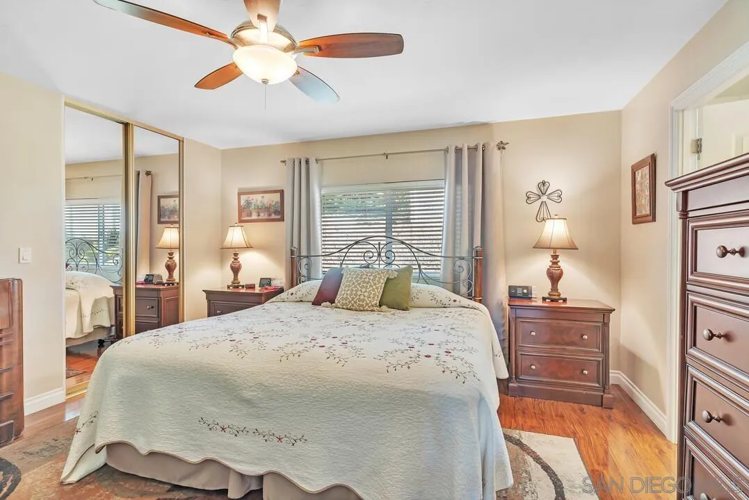 18218 Paradise Mountain Road, Unit 203 Valley Center, CA 92082 - Photo 37 of 68 a bedroom with a bed and wooden floor