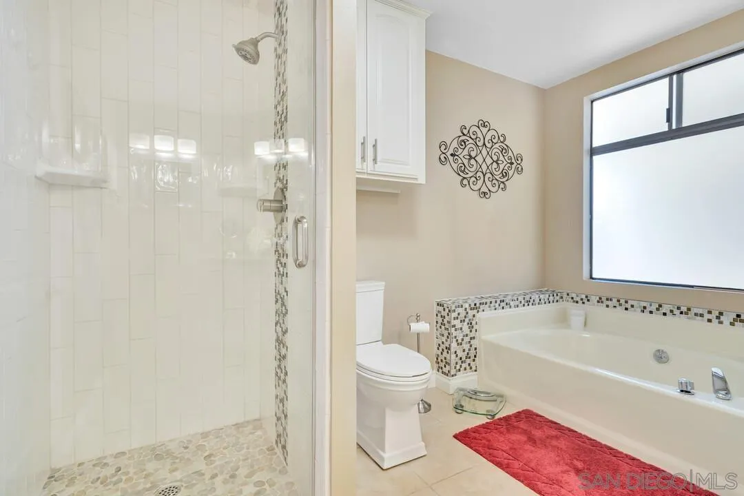 18218 Paradise Mountain Road, Unit 203 Valley Center, CA 92082 - Photo 40 of 68 a bathroom with a bathtub shower sink and toilet