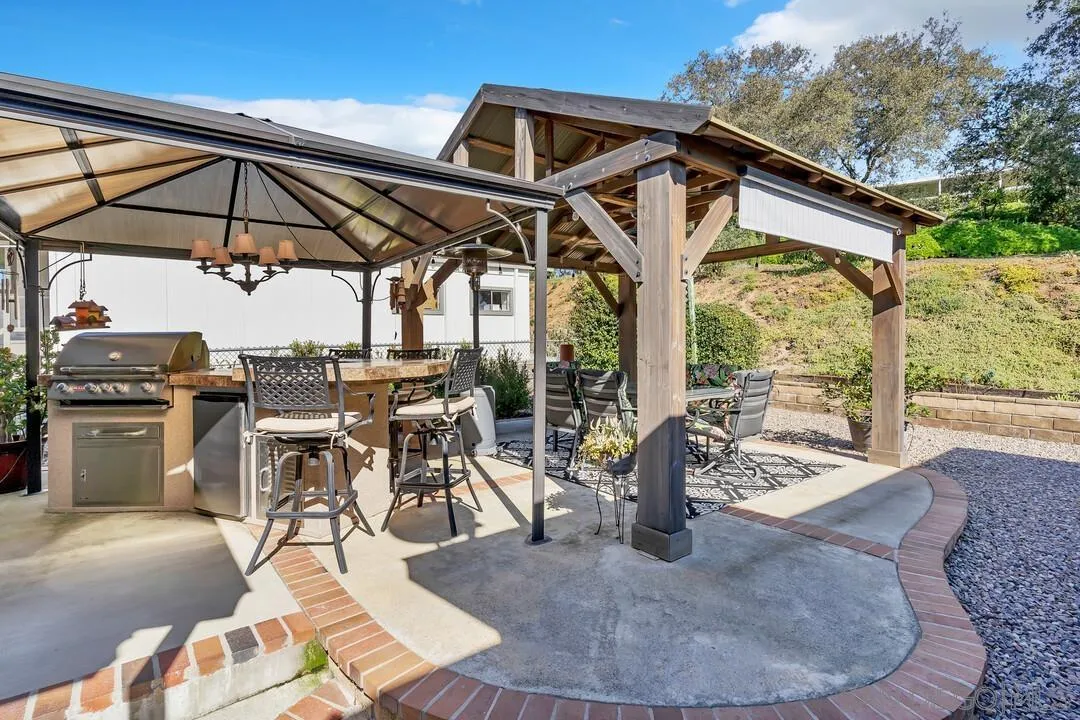 18218 Paradise Mountain Road, Unit 203 Valley Center, CA 92082 - Photo 10 of 68 a view of a patio with table and chairs