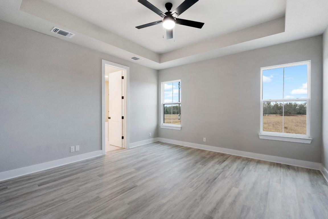 16544 Fm 112 Thrall, TX 76578 - Photo 14 of 28 a view of an empty room with wooden floor and a window