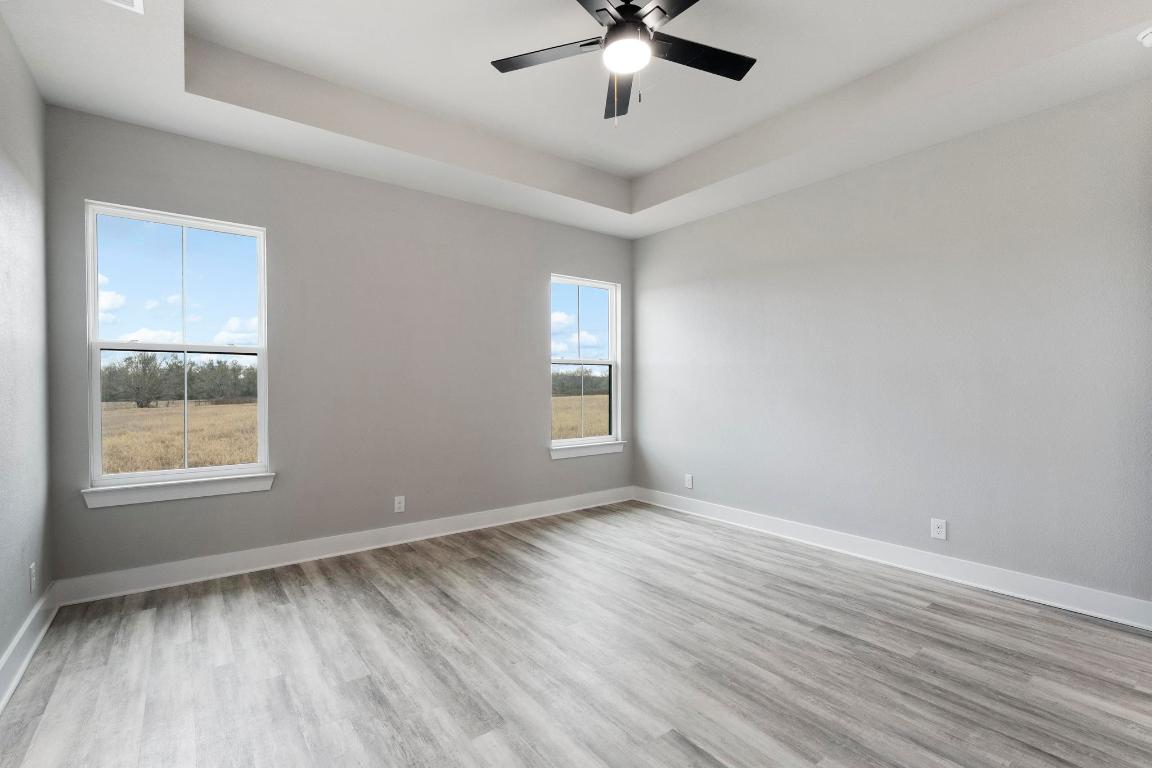 16544 Fm 112 Thrall, TX 76578 - Photo 15 of 28 a view of an empty room with wooden floor and a window