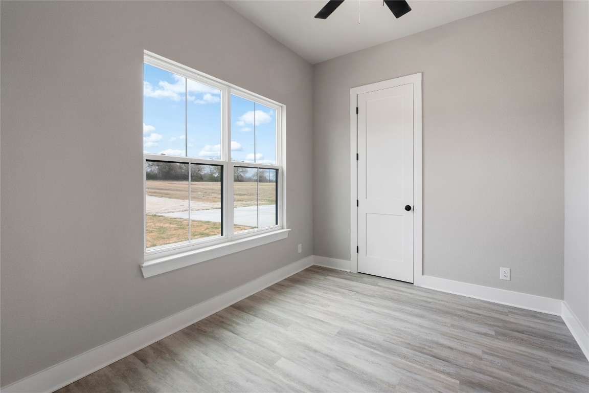 16544 Fm 112 Thrall, TX 76578 - Photo 24 of 28 an empty room with wooden floor and windows