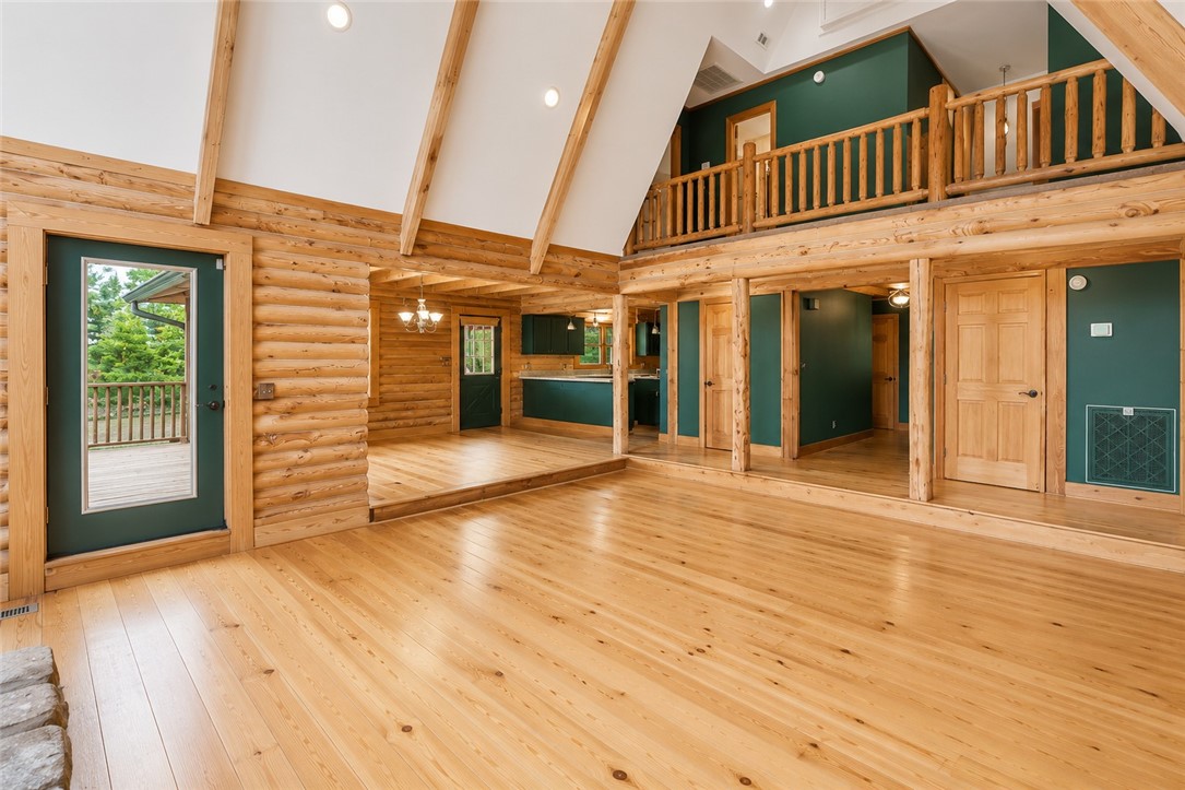414 Devon Way Anderson, SC 29621 - Photo 8 of 50 Natural wood logs and polished hardwood floors define this inviting open-concept living space with a loft overlook.