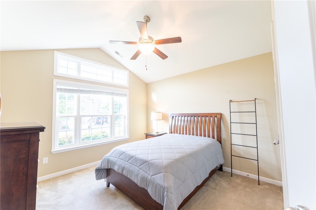 1012 Whirlaway Circle Anderson, SC 29621 - Photo 17 of 25 Natural light floods this inviting bedroom with vaulted ceilings and a warm, carpeted floor.