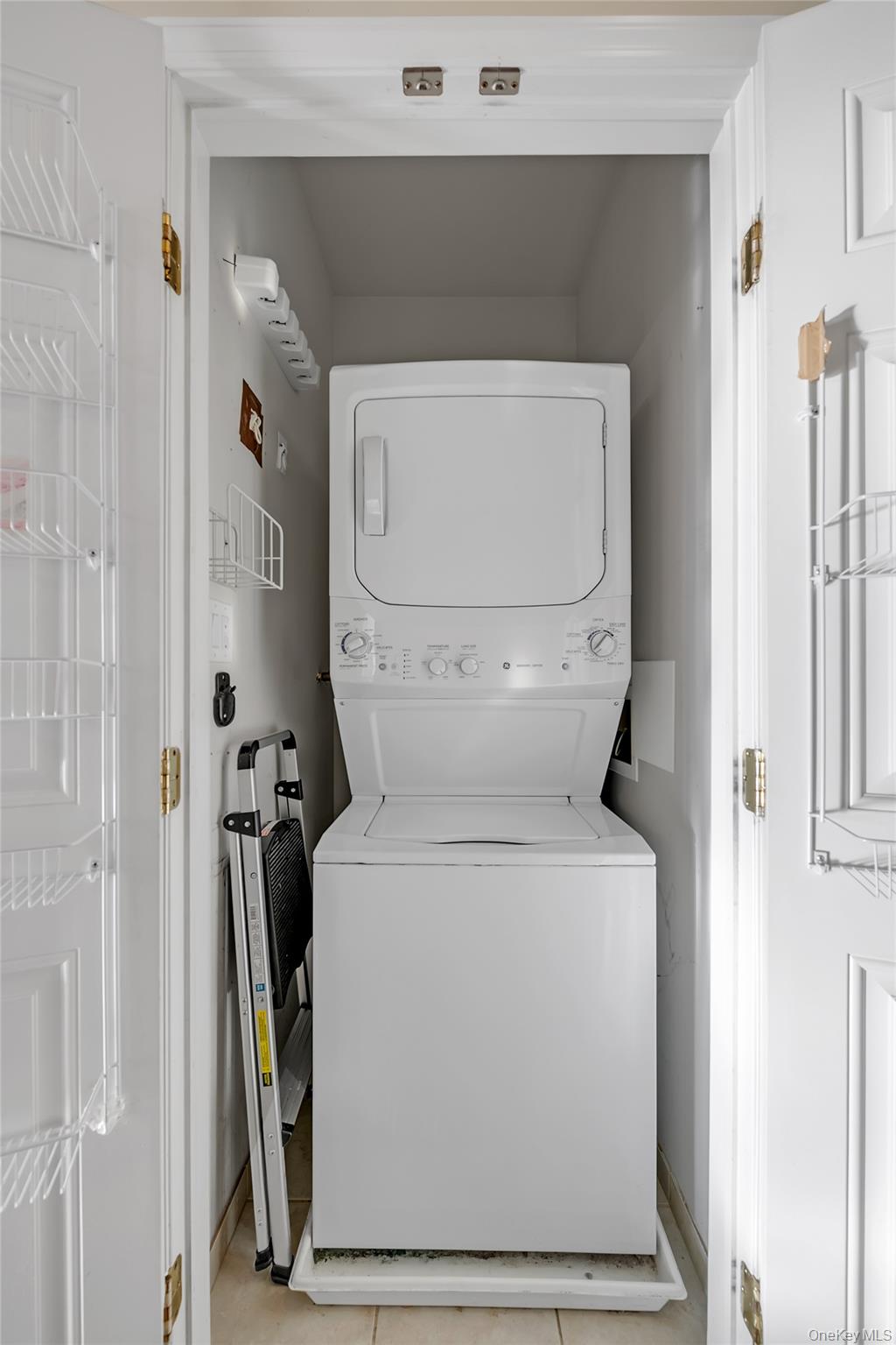 286 Spring Drive, Unit 286 East Meadow, NY 11554 - Photo 13 of 27 a utility room with dryer and washer