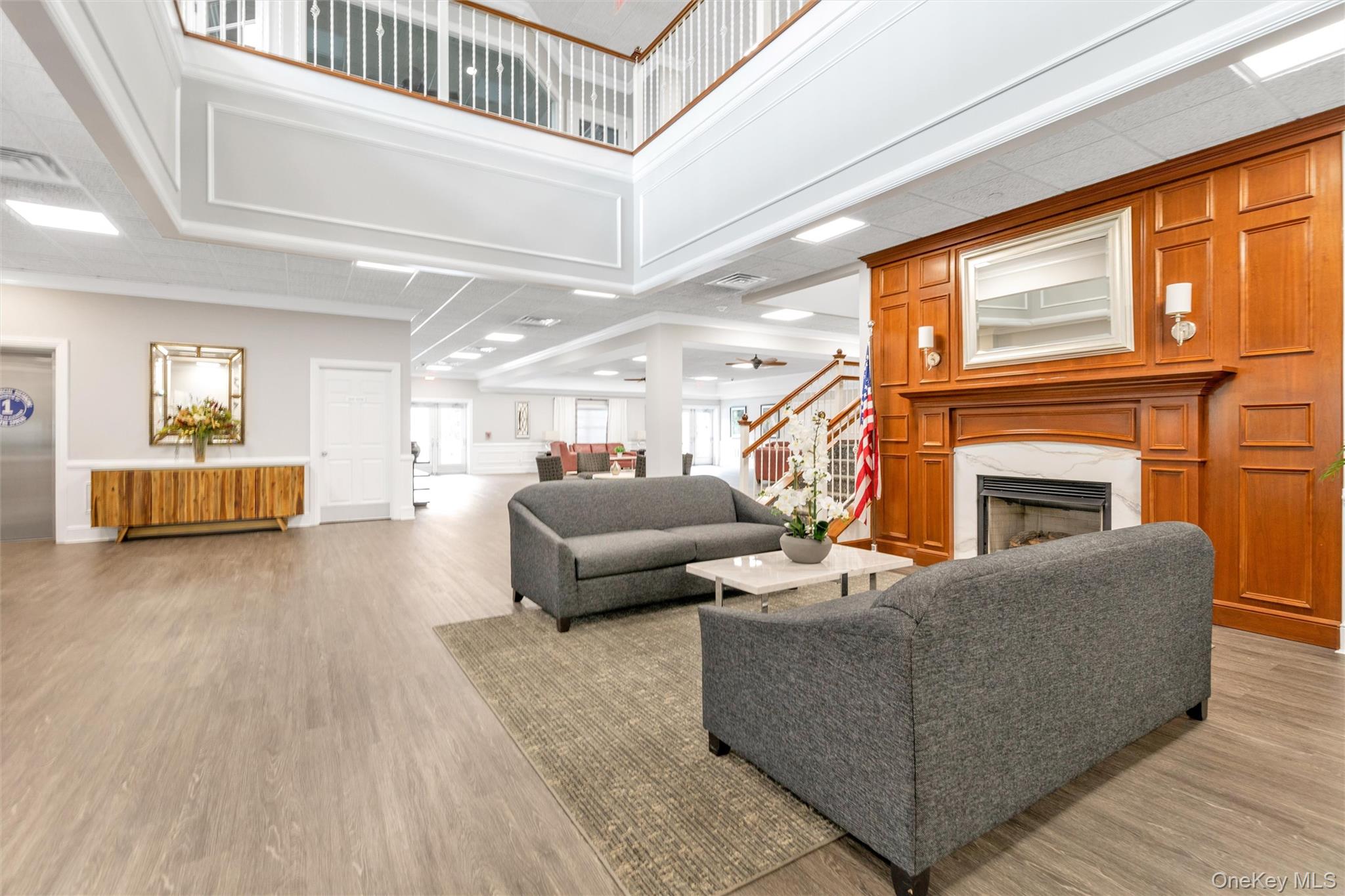 286 Spring Drive, Unit 286 East Meadow, NY 11554 - Photo 19 of 27 a living room with furniture and a fireplace