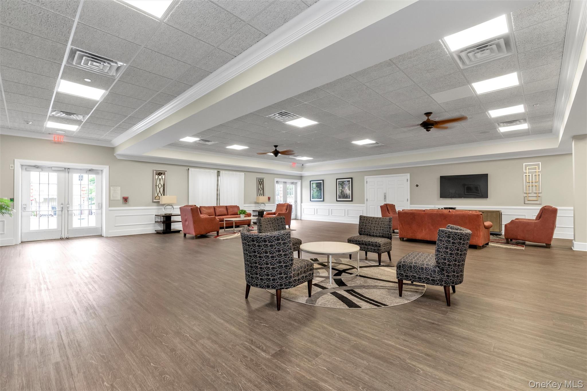286 Spring Drive, Unit 286 East Meadow, NY 11554 - Photo 21 of 27 a living room with furniture and a wooden floor