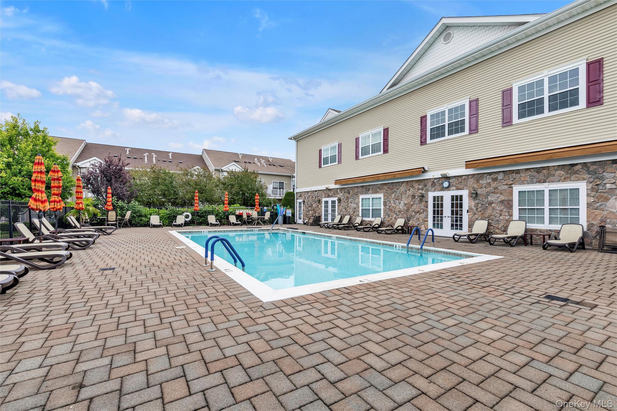 286 Spring Drive, Unit 286 East Meadow, NY 11554 - Photo 26 of 27 a view of a house with backyard porch and sitting area