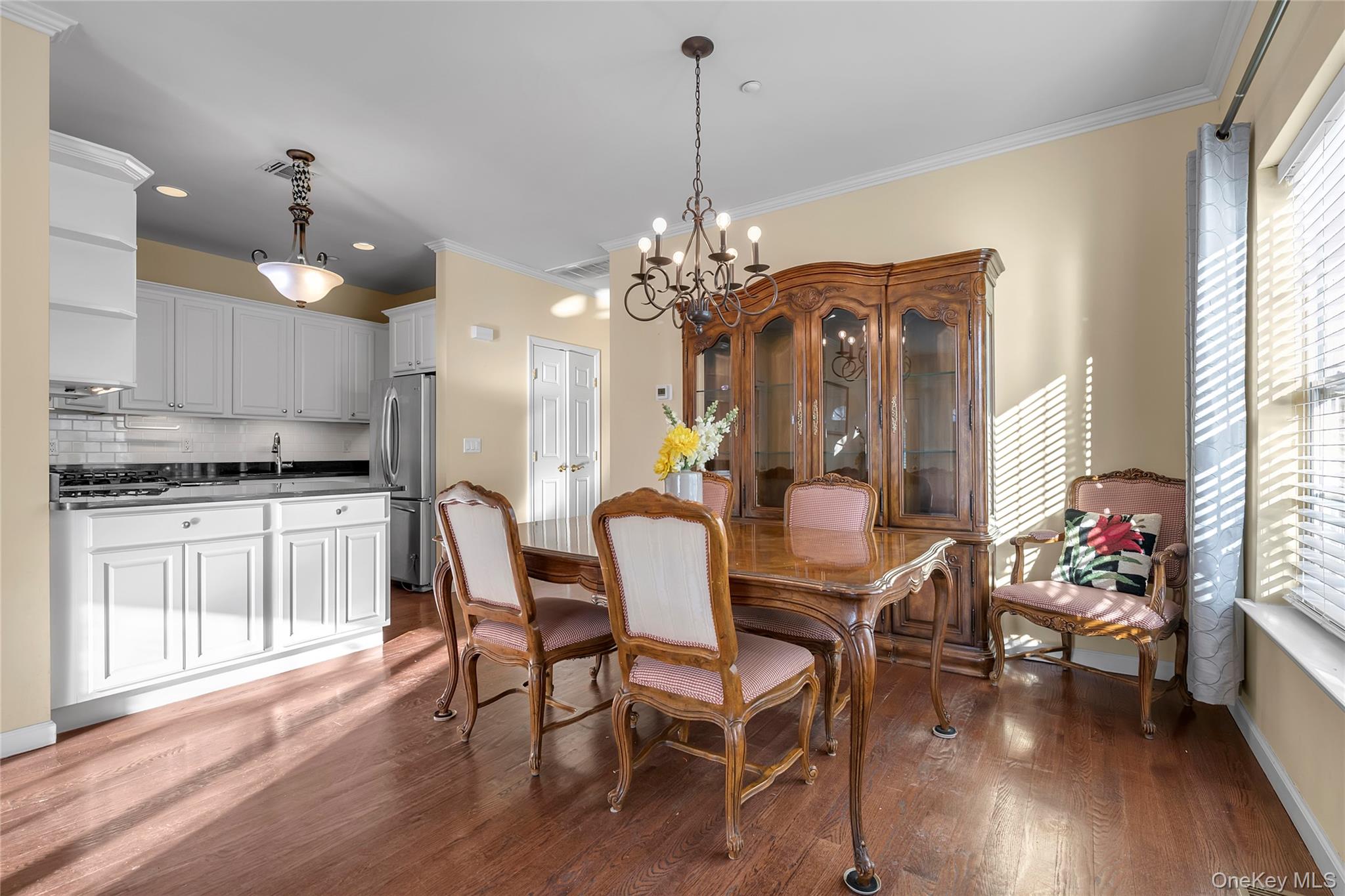 286 Spring Drive, Unit 286 East Meadow, NY 11554 - Photo 6 of 27 a view of a dining room with furniture window and wooden floor