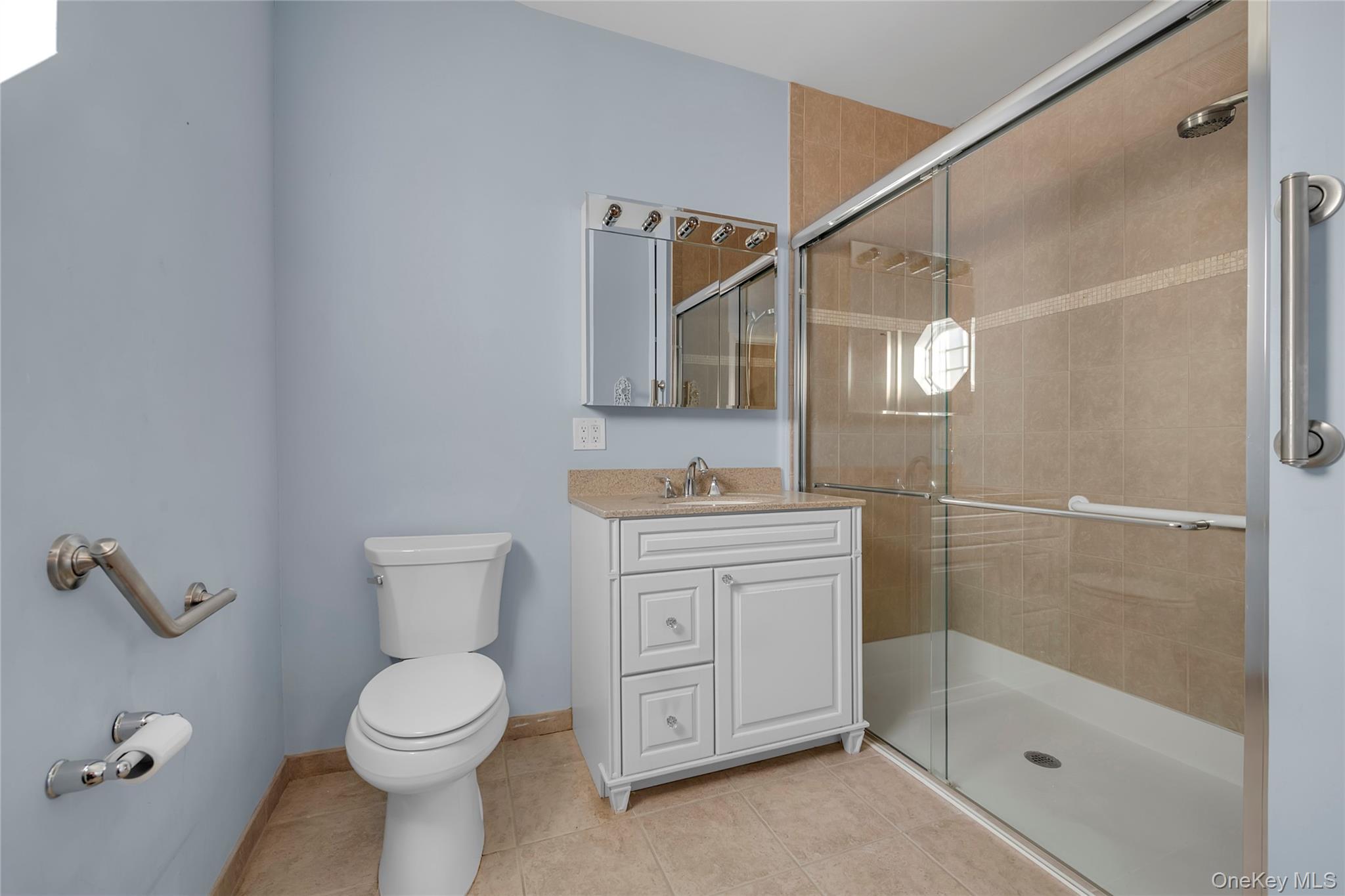 286 Spring Drive, Unit 286 East Meadow, NY 11554 - Photo 10 of 27 a bathroom with a granite countertop sink a toilet and shower