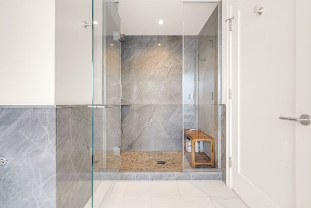 a bathroom with a shower and a mirror