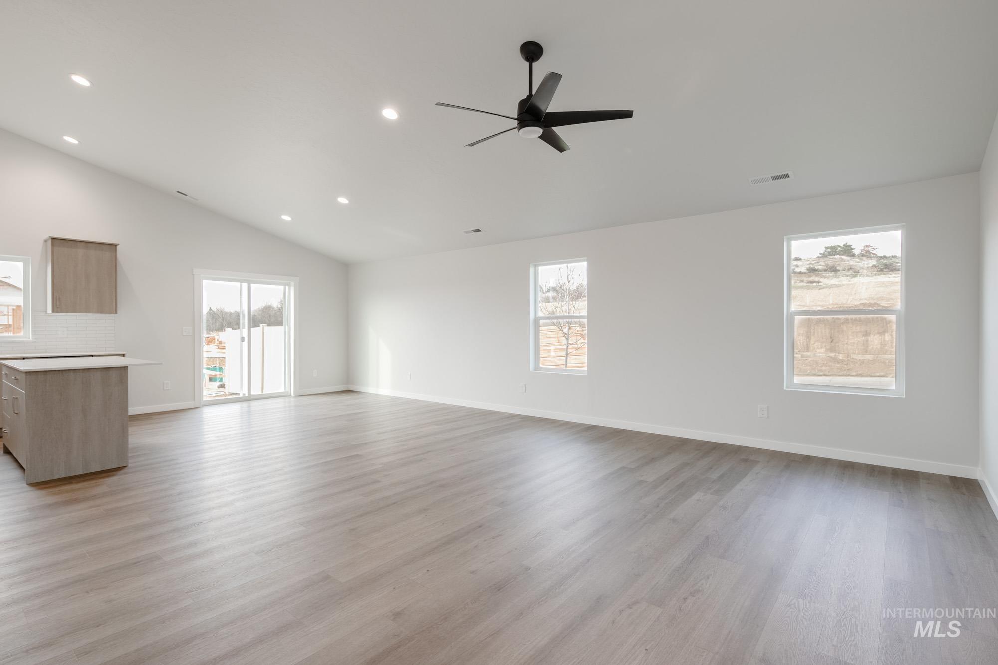3281 North Waterbrook Way Star, ID 83669 - Photo 11 of 21 Unfurnished living room featuring recessed lighting, light wood-style floors, plenty of natural light, vaulted ceiling, and ceiling fan