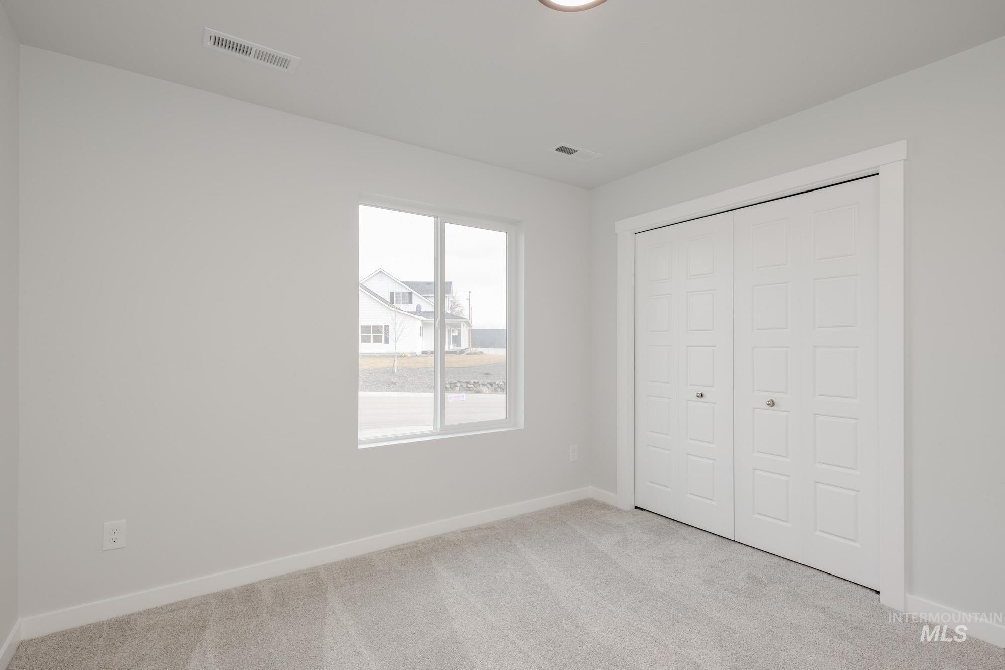 3281 North Waterbrook Way Star, ID 83669 - Photo 13 of 21 Unfurnished bedroom featuring light carpet and a closet