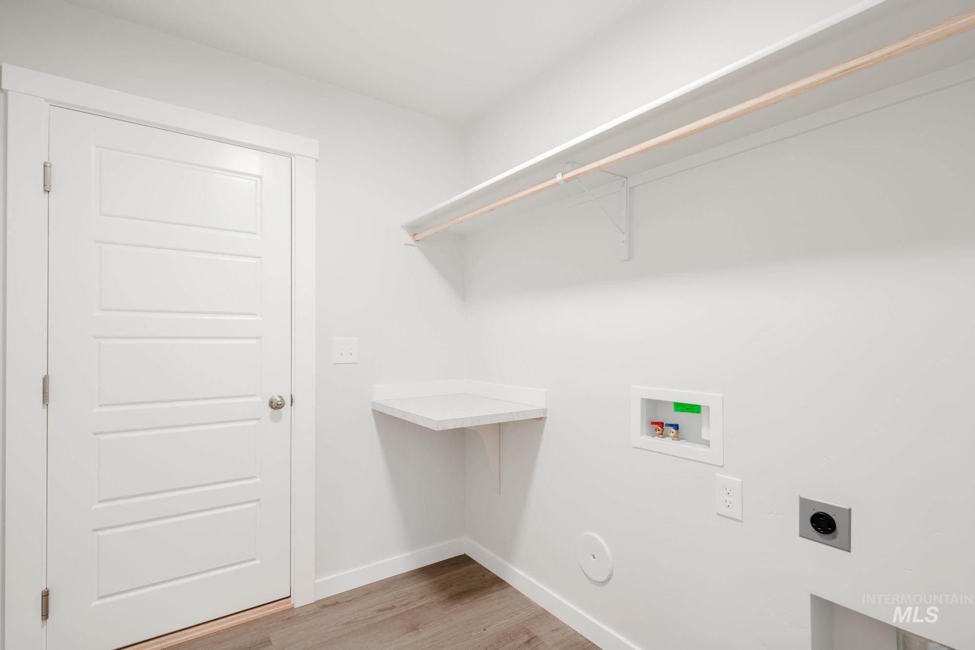 3281 North Waterbrook Way Star, ID 83669 - Photo 16 of 21 Laundry room featuring hookup for a washing machine, hookup for an electric dryer, and light wood-style flooring
