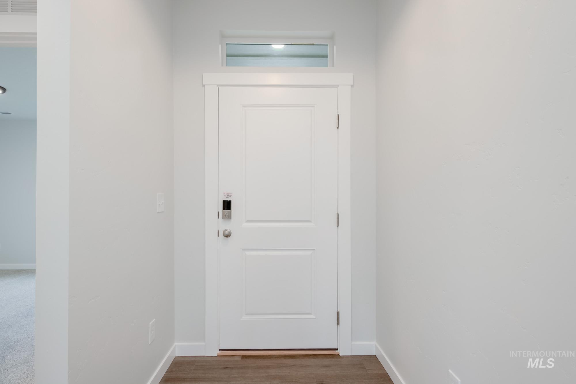 3281 North Waterbrook Way Star, ID 83669 - Photo 2 of 21 Doorway to outside featuring baseboards and wood finished floors