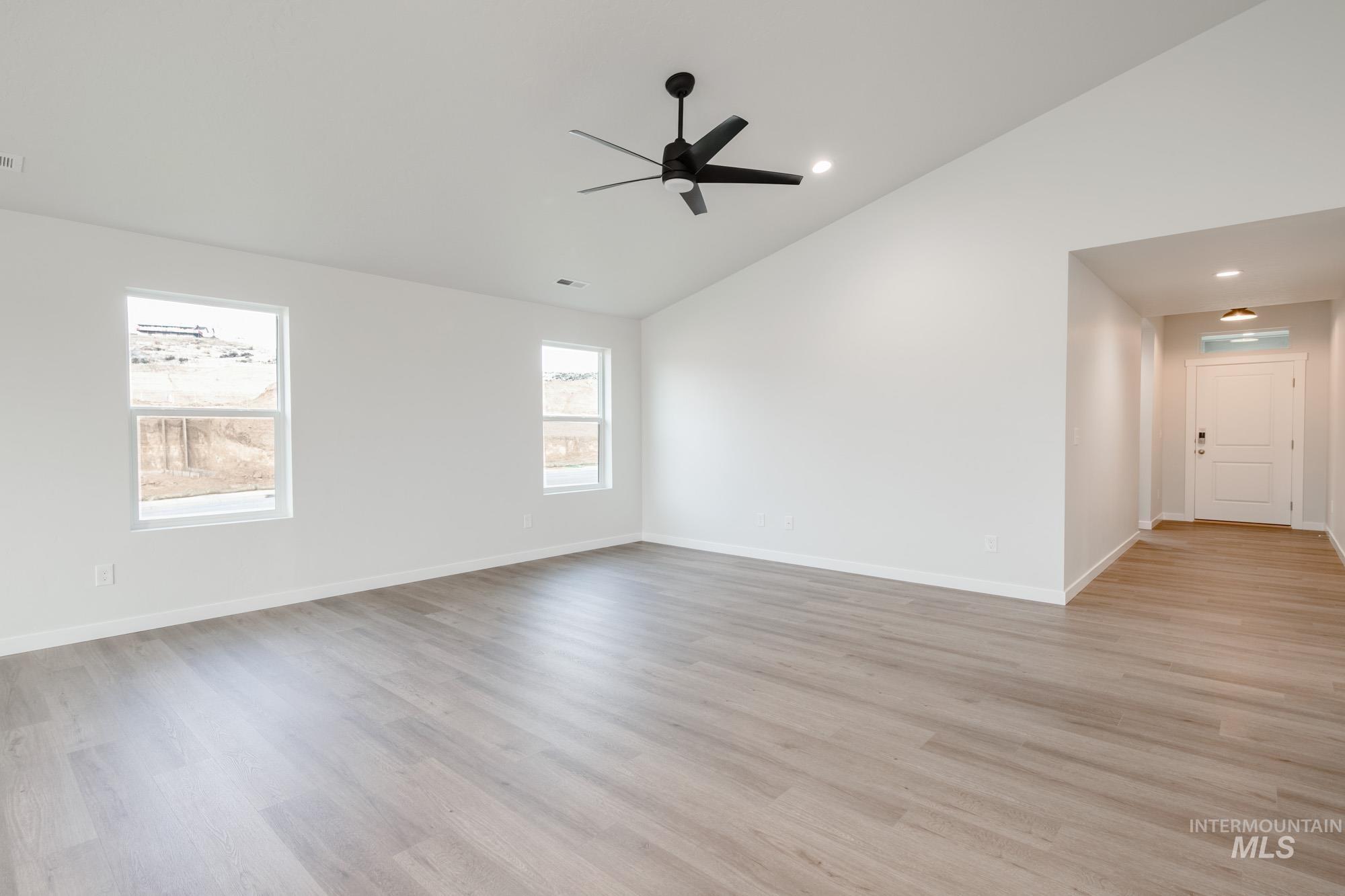 3281 North Waterbrook Way Star, ID 83669 - Photo 9 of 21 Spare room featuring light wood-style floors, recessed lighting, ceiling fan, and high vaulted ceiling