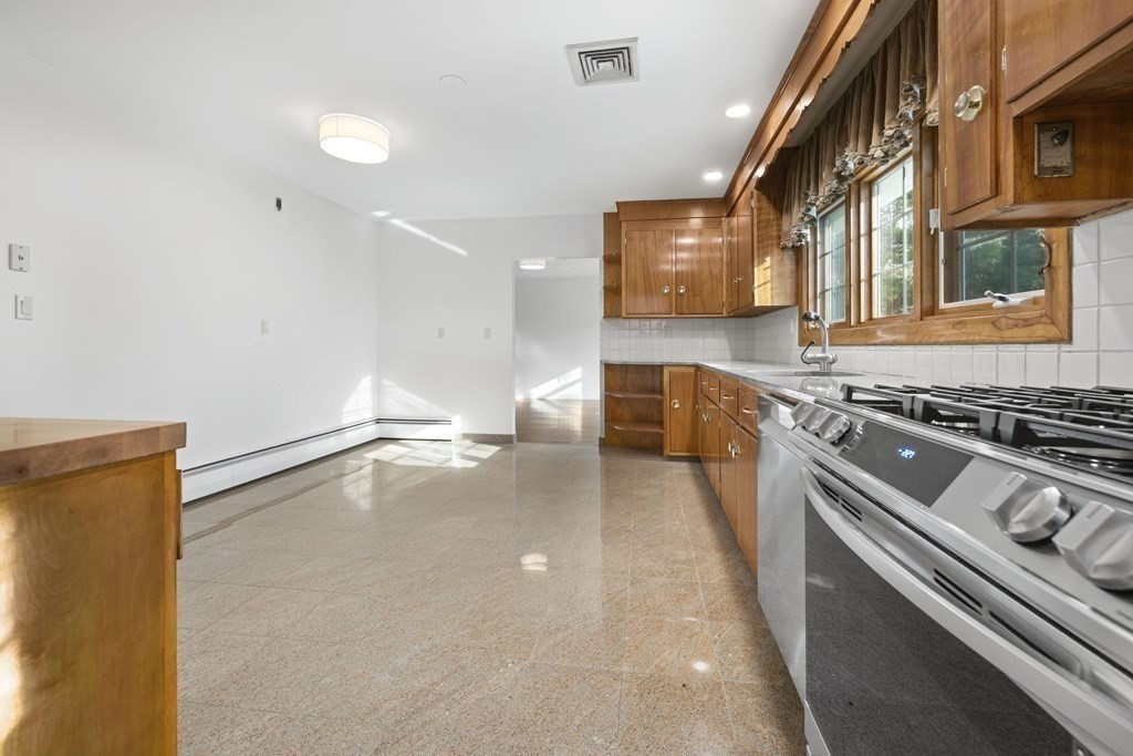 107 Boston Post Road Wayland, MA 01778 - Photo 13 of 42 a kitchen with stainless steel appliances a stove and a sink