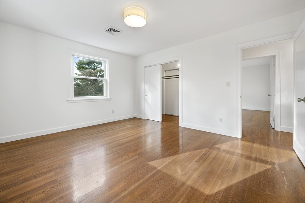 107 Boston Post Road Wayland, MA 01778 - Photo 15 of 42 an empty room with wooden floor and windows