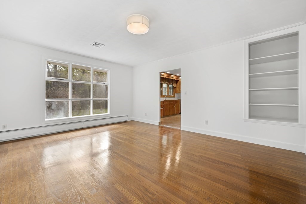 107 Boston Post Road Wayland, MA 01778 - Photo 21 of 42 a view of an empty room with wooden floor and a window