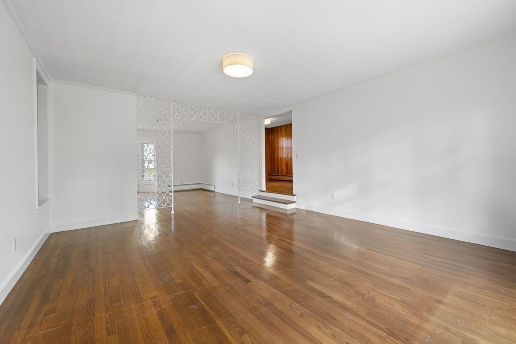 107 Boston Post Road Wayland, MA 01778 - Photo 22 of 42 a view of an empty room with wooden floor and a window