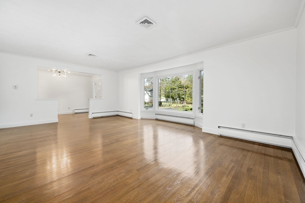 107 Boston Post Road Wayland, MA 01778 - Photo 24 of 42 an empty room with wooden floor and windows