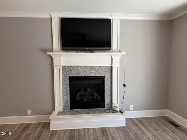 a living room with a fireplace and a flat screen tv