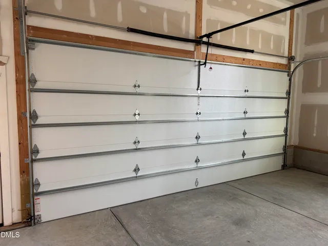 a view of a yard with plants and trees