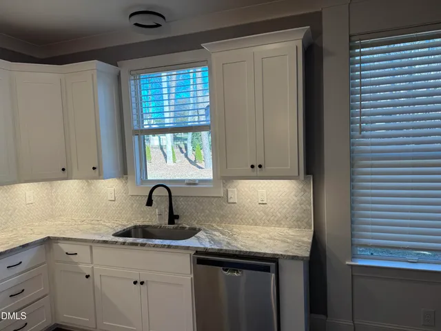 a kitchen with a sink and cabinets